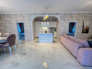 a living room with a couch and a table at Diamond Villas in Enina +1 photo