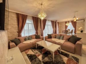 a living room with a couch and a table at Diamond Villas in Enina