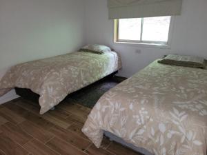 Postel nebo postele na pokoji v ubytování Cabañas Llifenativo