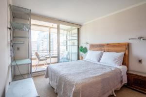a bedroom with a large bed and a balcony at Century View 2B W/Balcony, View & Parking. in Santiago