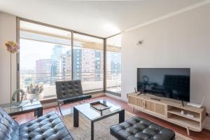 a living room with a couch and a large window at Century View 2B W/Balcony, View & Parking. in Santiago