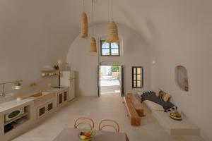 a kitchen and living room with a table and chairs at Elements Cave Suites in Megalokhori