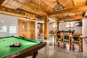 a living room with a pool table and dining room at Willa Mamcorka in Poronin