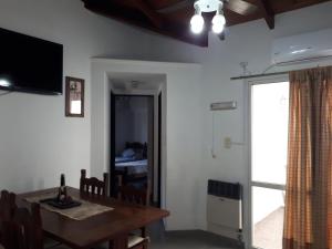 a dining room with a table and a television at Alojamientos Estrellas Azules in Colón