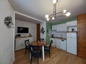 a kitchen and dining room with a table and chairs at REL'AX - T2 - Plein coeur Ax - Literie de qualité - Wifi - 200m télécabine in Ax-les-Thermes