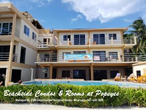a view of a resort with a swimming pool at Beach Club Budget Rooms at Popeyes Caye Caulker in Caye Caulker