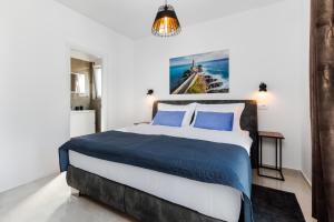 a bedroom with a large bed with blue pillows at Villa Mateo 2 in Ližnjan +26 photos