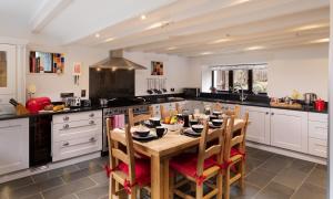 a large kitchen with a wooden table and chairs at Old Coach House in Ambleside