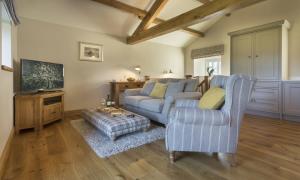a living room with a couch and a tv at Cedar Nook in Loweswater