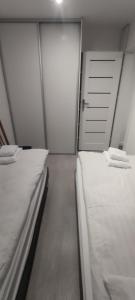 En eller flere senge i et værelse på Apartament Miedzianka III