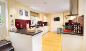 a large kitchen with a large island in a room at Scots Pine in Keswick