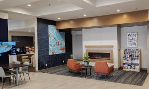 a waiting room with chairs and a fireplace at Holiday Inn Express & Suites Salt Lake City N - Bountiful in Bountiful