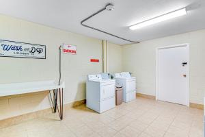 a utility room with a washing machine and a sink at Top of the Gulf 702 Teal Waters in Panama City Beach