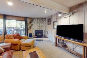 a living room with a large flat screen tv at Sherwin Villas 12 B in Mammoth Lakes