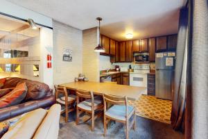 a kitchen and dining room with a table and a couch at Sherwin Villas 12 B in Mammoth Lakes