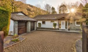 a house with a garage and a driveway at Lanterns At Grasmere in Grasmere