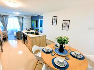 a kitchen and dining room with a table and chairs at Pristine King Size Bed Apartment In Secure Complex in Durban