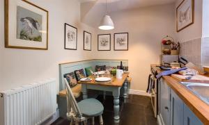 a small kitchen with a table and a sink at The Blithe Hare in Windermere