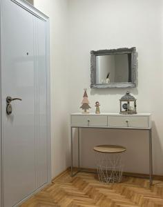 a bathroom with a vanity and a mirror on the wall at Apartman Divine in Banja Luka
