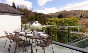 a table and chairs on the balcony of a house at Hillhead in Ambleside