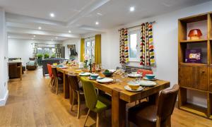 a dining room with a long wooden table and chairs at Wynford in Ambleside