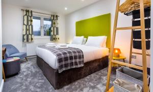 a bedroom with a bed and a bunk bed at Wynford in Ambleside