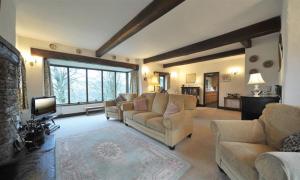 a large living room with couches and a tv at Butt Hill Cottage in Troutbeck