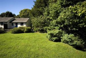 アンブルサイドにあるRiverside Cottages No 2の緑の草木のある庭のある家