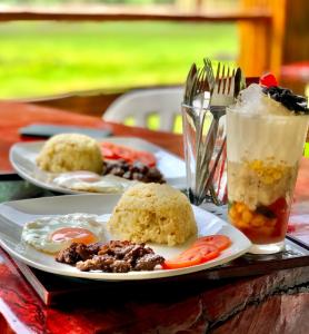 a table with two plates of food and a drink at Mount Avangan Eco Adventure Park in Coron