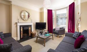 a living room with two couches and a fireplace at Highbank in Bowness-on-Windermere