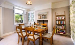 a dining room with a wooden table and chairs at Highbank in Bowness-on-Windermere