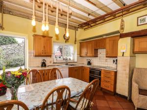 a kitchen with a table and chairs and a table and a counter at Raisthwaite Farm in Broughton in Furness