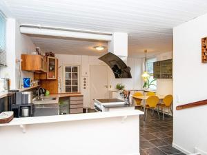 a kitchen and dining room with a table and chairs at Holiday home Nørre Snede in Nørre Snede