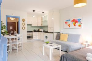 a living room and kitchen with a couch and a table at GOLD - Vilamoura in Vilamoura