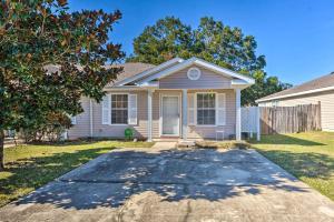 a house with a driveway in front of it at Cute Pensacola Townhome about 9 Mi to Downtown! in Pensacola