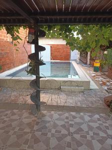 a group of chairs sitting next to a swimming pool at Departamentos Temporarios Aeropuerto in Formosa