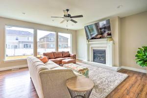 een woonkamer met een bank en een open haard bij Family-Friendly Orem Home with Pool Access! in Orem