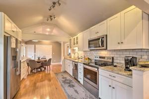 a kitchen with white cabinets and a table with chairs at Luxe Lyndon Home Less Than 11 Mi to Dtwn Louisville! in Louisville