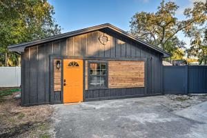 een zwarte garage met een oranje deur bij Cozy Brandon Guest Studio with Pool and Hot Tub! in Brandon
