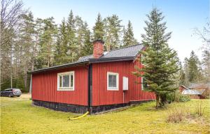 a red house with a chimney and a tree at Beautiful Home In Lnneberga With 2 Bedrooms in Lönneberga