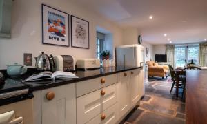 a kitchen with a counter top with a refrigerator at Stone Arthur Cottage in Grasmere