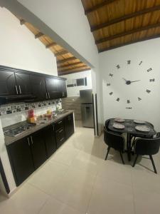 a kitchen with a large clock on the wall at Apartamento de descaso por san Gil in San Gil