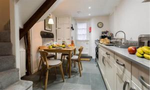 a kitchen with a table and chairs in a room at Lettera in Ambleside