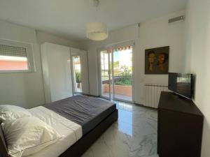 a bedroom with a bed and a television in it at Centoventinove in Carrara
