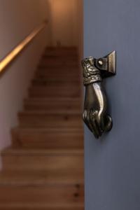 a metal door handle on a stairway with stairs at Casas da Oliveira in Setúbal