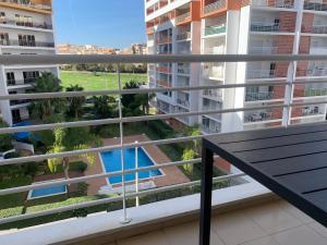 a balcony with a bench and a view of a pool at ConVistaApartment with Pool in Portimão