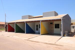 a building with colorful paint on the side at FlatsMedrado in Confresa