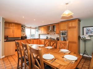 a kitchen with a wooden table and chairs at Candleberry Cottage in Ambleside
