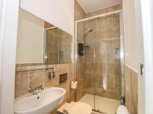 a bathroom with a sink and a shower at Candleberry Cottage in Ambleside