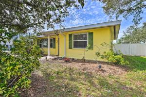 a yellow house with a yard at Nokomis Home with Gas Grill 2 Blocks to Beach! in Nokomis